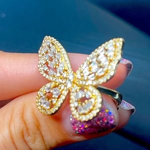 Ring. Not gold. Butterfly . Very shiny on the sun, looks perfect in night clubs.